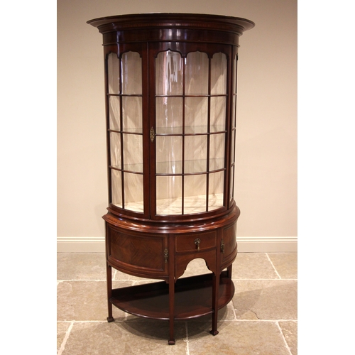 1049 - An Edwardian mahogany bow front display cabinet, in the manner of Edwards and Roberts, with an overs... 