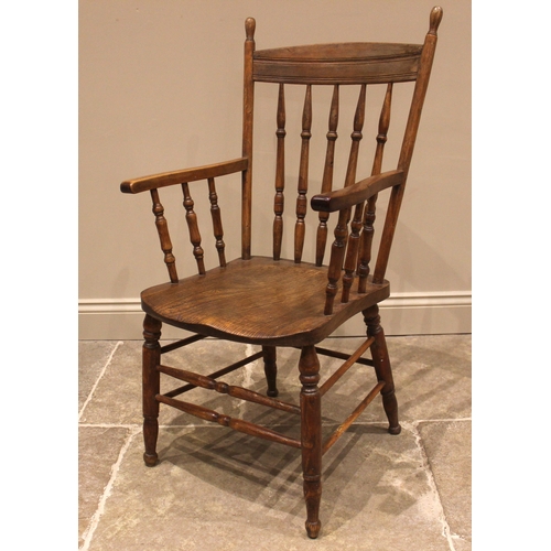 1052 - An elm and beech kitchen elbow chair, late 19th/early 20th century, the concave back rail upon turne... 