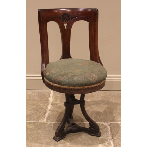 1056 - A walnut and upholstered revolving ships office chair, late 19th early/20th century, the concave top... 