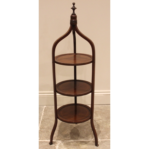 1059 - An Edwardian mahogany cake stand, outlined with boxwood stringing, the frame of ogee form with three... 