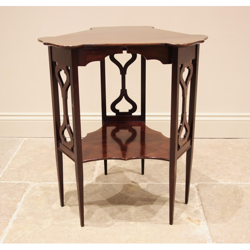 1061 - An Edwardian Art Nouveau mahogany occasional table, in the manner of J.S. Henry, London, the triform... 