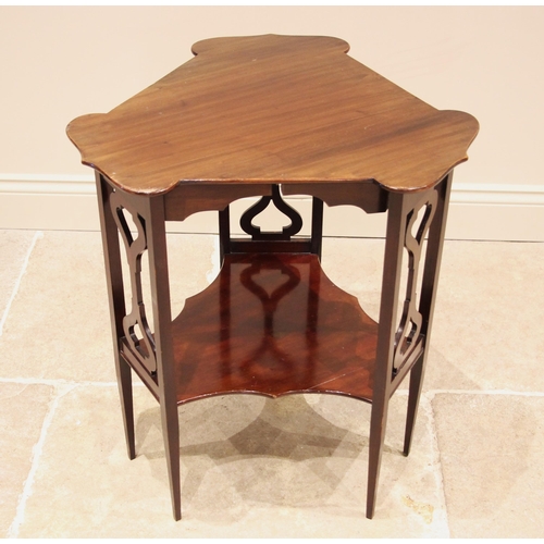 1061 - An Edwardian Art Nouveau mahogany occasional table, in the manner of J.S. Henry, London, the triform... 