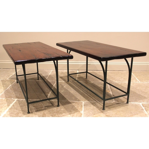 1064 - A pair of hardwood slab top side tables, mid to late 20th century, the polished slab tops raised upo... 