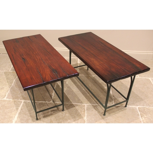 1064 - A pair of hardwood slab top side tables, mid to late 20th century, the polished slab tops raised upo... 