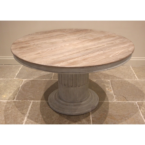 1075 - An Oka limed oak and painted pedestal centre table, early 21st century, the moulded circular top upo... 