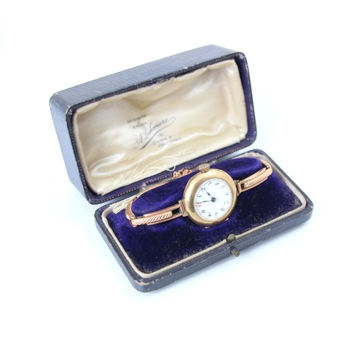 113 - A 9ct yellow metal ladies wristwatch, the white enamel dial with Arabic numerals, set to plain polis... 