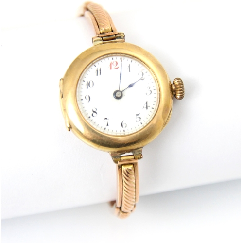 113 - A 9ct yellow metal ladies wristwatch, the white enamel dial with Arabic numerals, set to plain polis... 