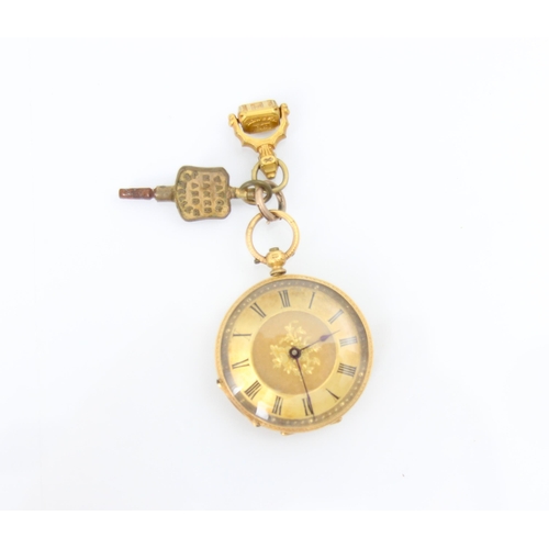 117 - A late 19th century yellow metal ladies fob watch, the gold coloured dial with central engraved flor... 