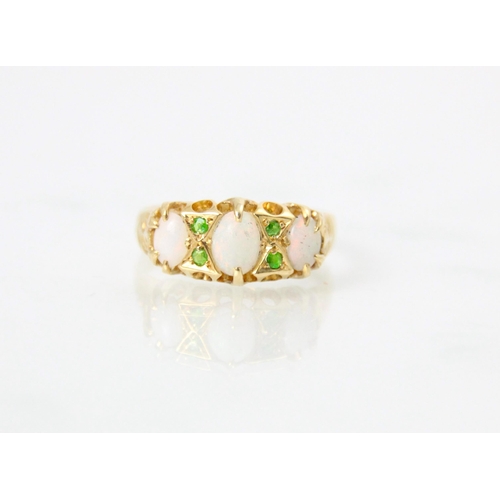 128 - An 18ct yellow gold opal and demantoid garnet ring, the central oval cabochon opal with a further sm... 