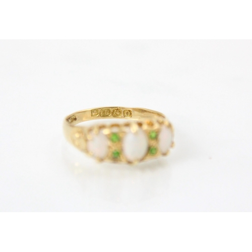 128 - An 18ct yellow gold opal and demantoid garnet ring, the central oval cabochon opal with a further sm... 