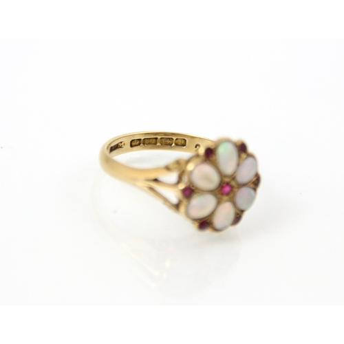 129 - An 18ct yellow gold opal and untested ruby cluster ring, the oval cabochon opals within a petal desi... 