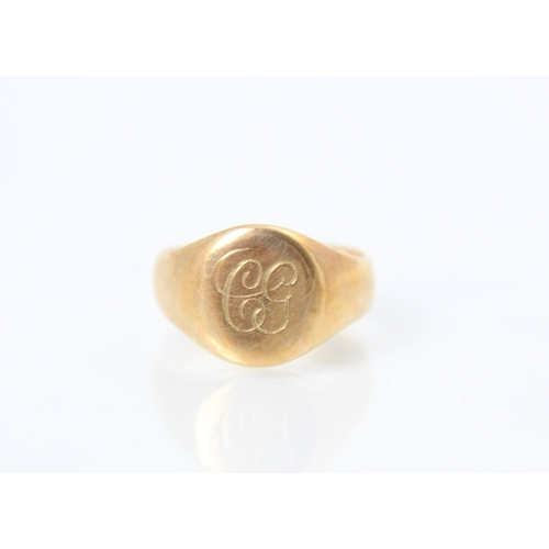 135 - A 9ct yellow gold signet ring, the oval cartouche with 'CG' monogram leading to plain polished shank... 