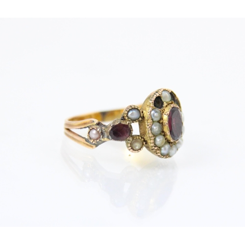 137 - A 19th century split pearl and red stone ring, the red stone centre (possibly foil backed) with surr... 