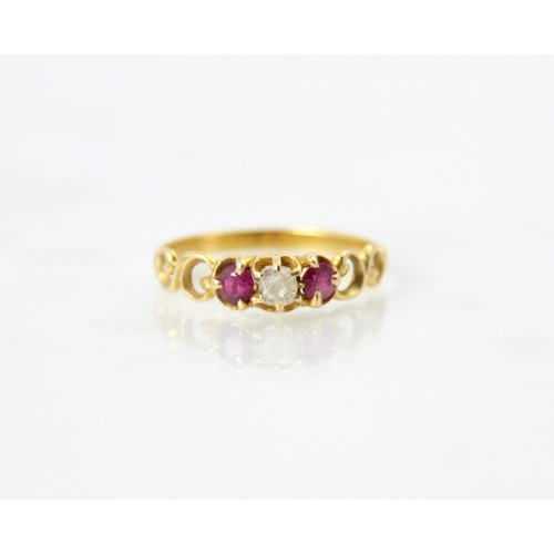 147 - A 20th century diamond ring, the old cut diamond with a red stone set to each side, within openwork ... 