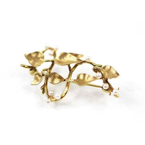 149 - A late 20th century 9ct yellow gold and seed pearl spray brooch, the plain polished stylised stem wi... 