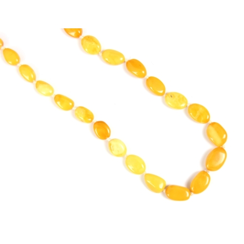 162 - A string of butterscotch coloured amber beads, the non uniform disc shaped beads, with a further str... 