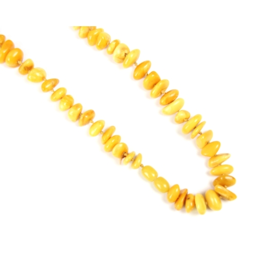 162 - A string of butterscotch coloured amber beads, the non uniform disc shaped beads, with a further str... 