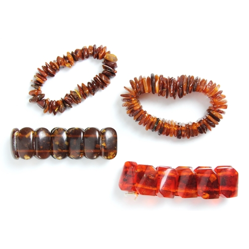 165 - A group of four 'amber' bracelets, to include a fragmented examples of non uniform design, a further... 