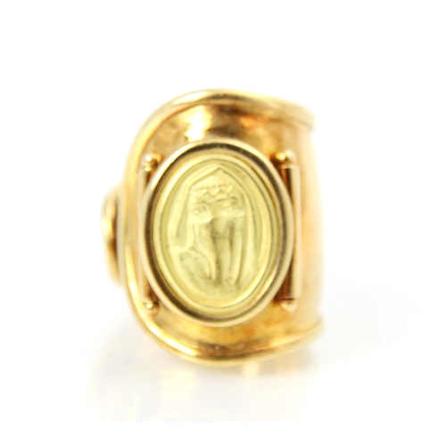 168 - A yellow metal dress ring, the tapered open ring with applied oval pad depicting lady, ring size N, ... 