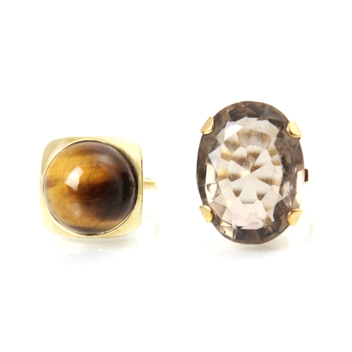 172 - Two yellow metal dress rings, to including a tigers eye dress ring, the circular cabochon tigers eye... 