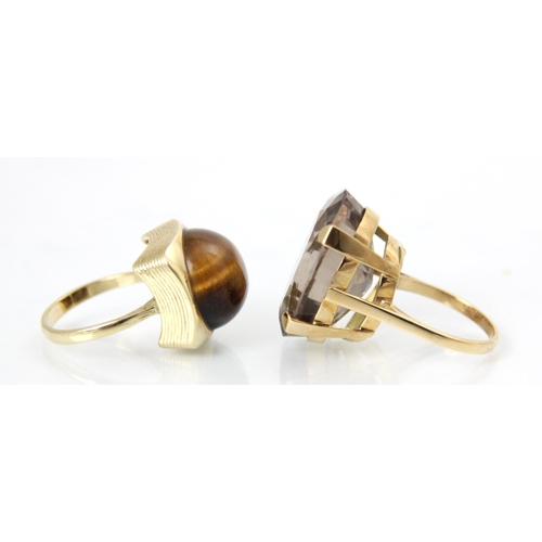 172 - Two yellow metal dress rings, to including a tigers eye dress ring, the circular cabochon tigers eye... 