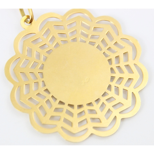 175 - A yellow metal openwork pendant and chain, the openwork scalloped edged pendant with central raised ... 