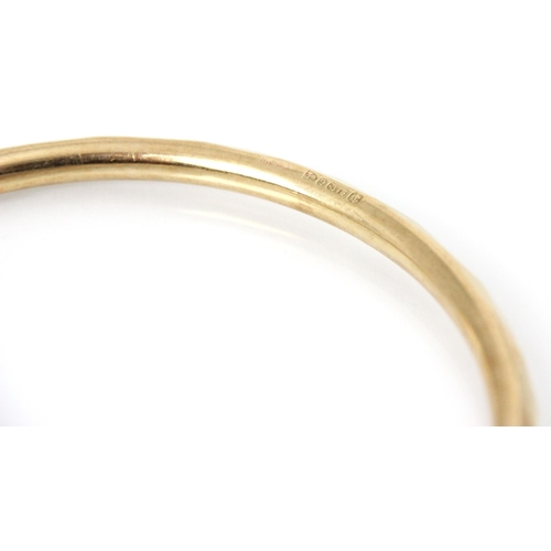 178 - A 9ct yellow gold bangle, the hollow bangle with faceted detail to exterior, stamped Chester 1928, 9... 