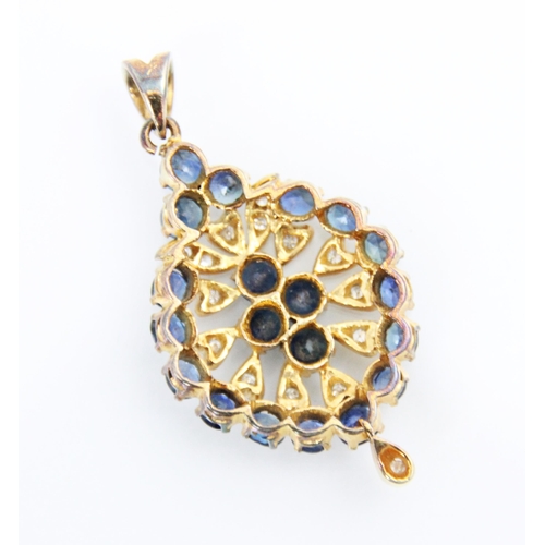 189 - A late 20th century diamond and synthetic sapphire pendant, the lozenge shaped pendant set with an o... 