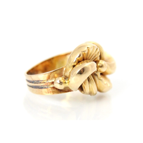 202 - A yellow metal dress ring, the stylised lobed head with textured and plain polished detail, leading ... 