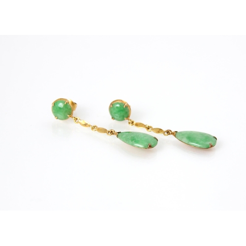 213 - A pair of untested jade earrings, the cabochon cut green stone stud within yellow metal mount, with ... 