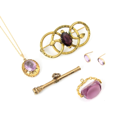 219 - A 9ct yellow gold amethyst set pendant, the oval cut stone within engraved mount, upon associated tr... 