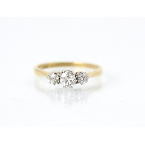 220 - An early 20th century diamond three stone ring, the central old cut diamond with smaller old cut dia... 