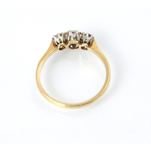 220 - An early 20th century diamond three stone ring, the central old cut diamond with smaller old cut dia... 