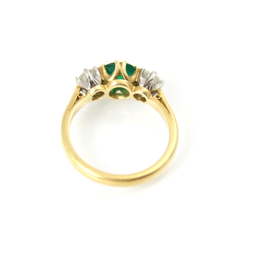 222 - An 18ct yellow gold untested emerald and diamond three stone ring, the central round cut green stone... 