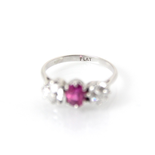 223 - An early 20th century pink sapphire and diamond three stone ring, the central oval cut pink stone wi... 