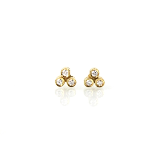 238 - A pair of Cartier diamond set stud earrings, stamped ‘Cartier 750’ to reverse, the trefoil designed ... 