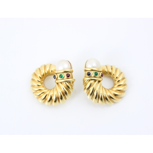 242 - A pair of yellow metal earrings, the stylised swirl earrings with paste pearl terminals and blue, re... 