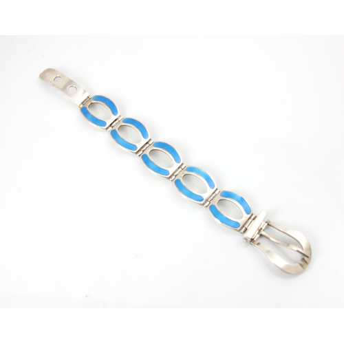 244 - A silver and enamel bracelet, the oval links with blue enamel with stylised buckle fastening, stampe... 