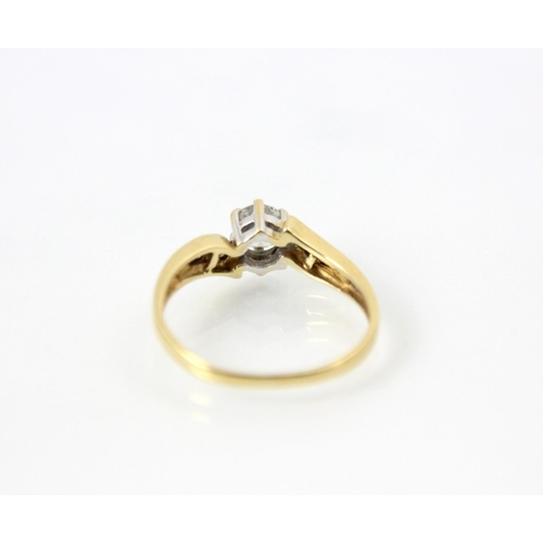 249 - A diamond solitaire ring, the central round cut diamond within yellow gold mount with diamond set sh... 