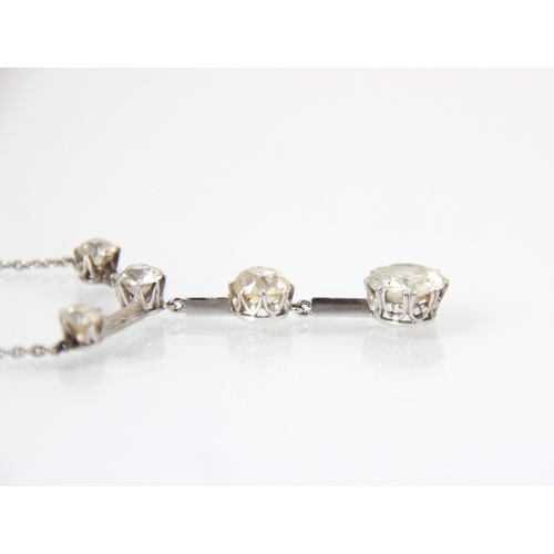 250 - An early 20th century negligee style set necklace, the row of three old cut diamonds separated by a ... 