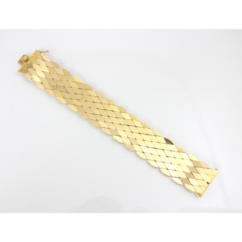 251 - A yellow metal bracelet, the flat lozenge shaped links with box and tongue fastening, stamped ‘750’ ... 