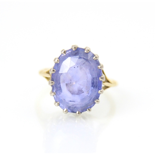 256 - An early 20th century style untested sapphire ring, the oval cut blue stone in white metal claw sett... 