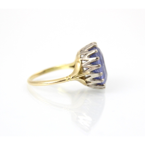 256 - An early 20th century style untested sapphire ring, the oval cut blue stone in white metal claw sett... 