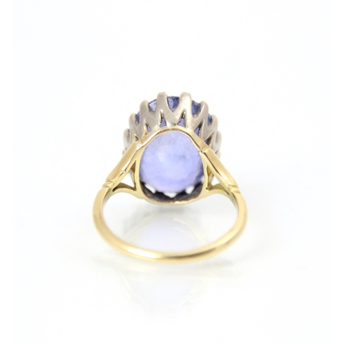 256 - An early 20th century style untested sapphire ring, the oval cut blue stone in white metal claw sett... 