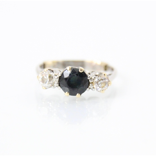 258 - An early 20th century diamond and sapphire three stone ring, the central round cut sapphire with an ... 