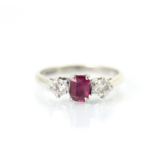 260 - A 9ct white gold synthetic ruby and diamond three stone ring, the rectangular cut synthetic ruby wit... 