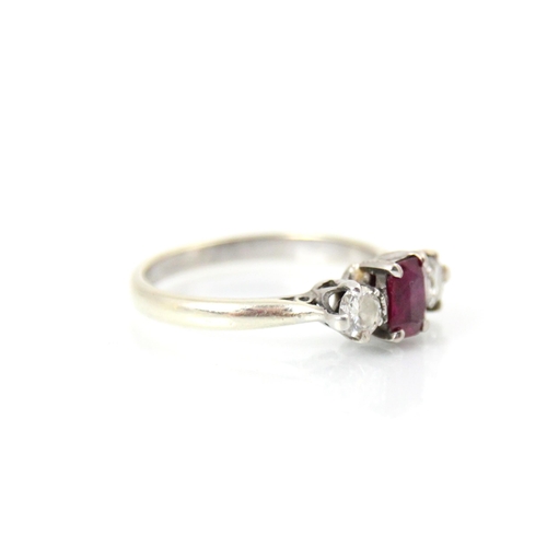 260 - A 9ct white gold synthetic ruby and diamond three stone ring, the rectangular cut synthetic ruby wit... 