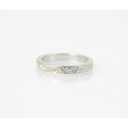 261 - A white metal band ring, with continuous engraved detail to exterior, stamped ‘MBs’ Birmingham, ring... 