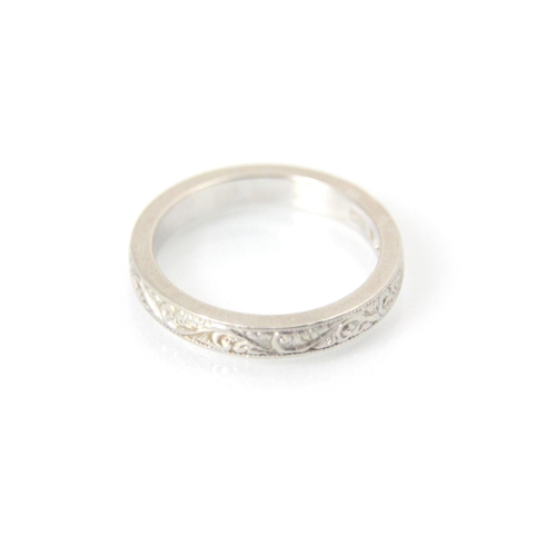 261 - A white metal band ring, with continuous engraved detail to exterior, stamped ‘MBs’ Birmingham, ring... 