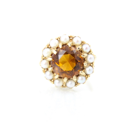 264 - A late 20th century citrine and cultured pearl cluster ring, the central round cut citrine within a ... 